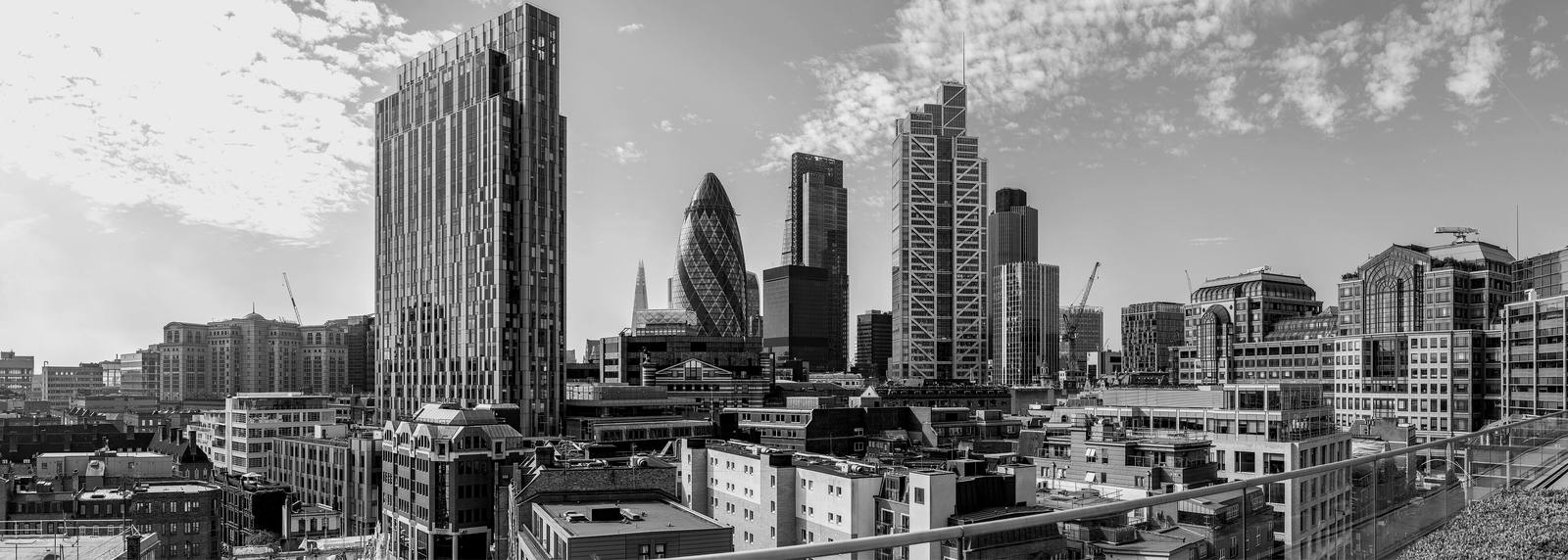 Towers of the City of London seen from a rooftop, in black and white